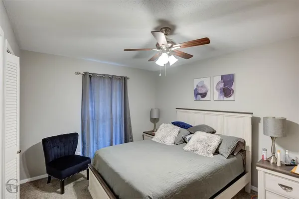 a bedroom with a bed and a chair