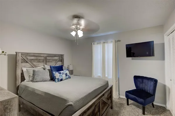 a bedroom with a bed and a television