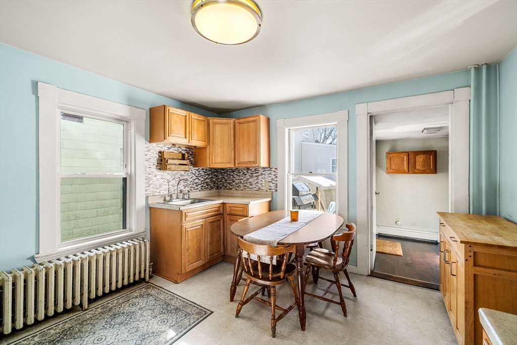 12 Arthur Street Gloucester, MA 01930 - Photo 11 of 33 a kitchen with a dining table chairs and large window