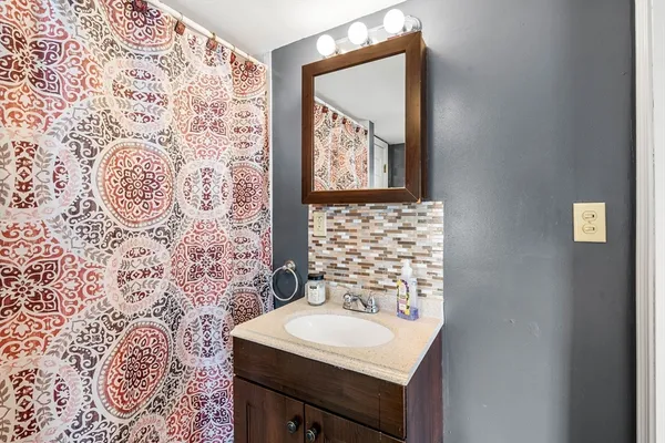 a bathroom with a sink and a mirror