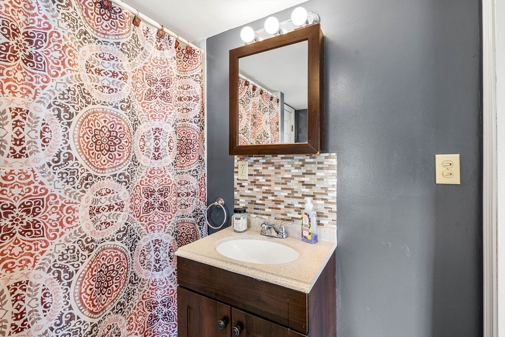 12 Arthur Street Gloucester, MA 01930 - Photo 14 of 33 a bathroom with a sink and a mirror