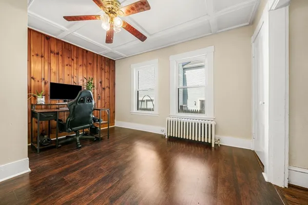 a view of livingroom with hardwood floor and a ceiling fan