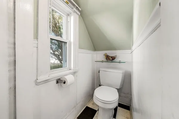 a bathroom with a toilet sink and a window