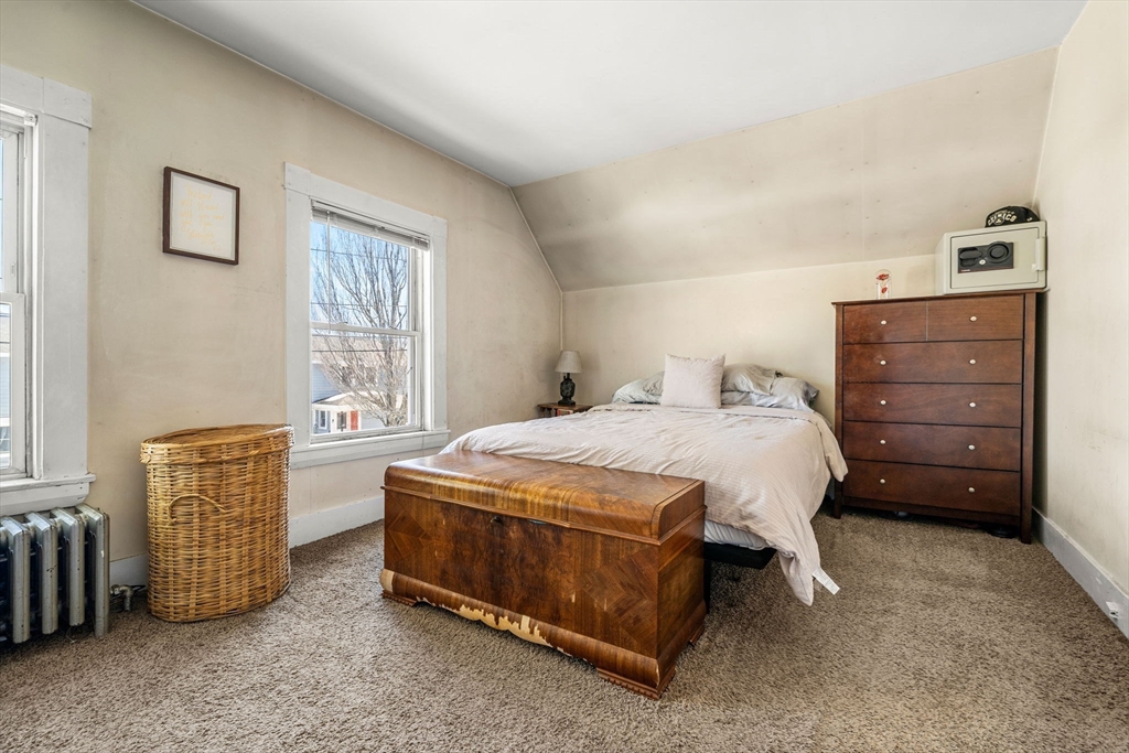 12 Arthur Street Gloucester, MA 01930 - Photo 19 of 33 a bedroom with a bed and a window