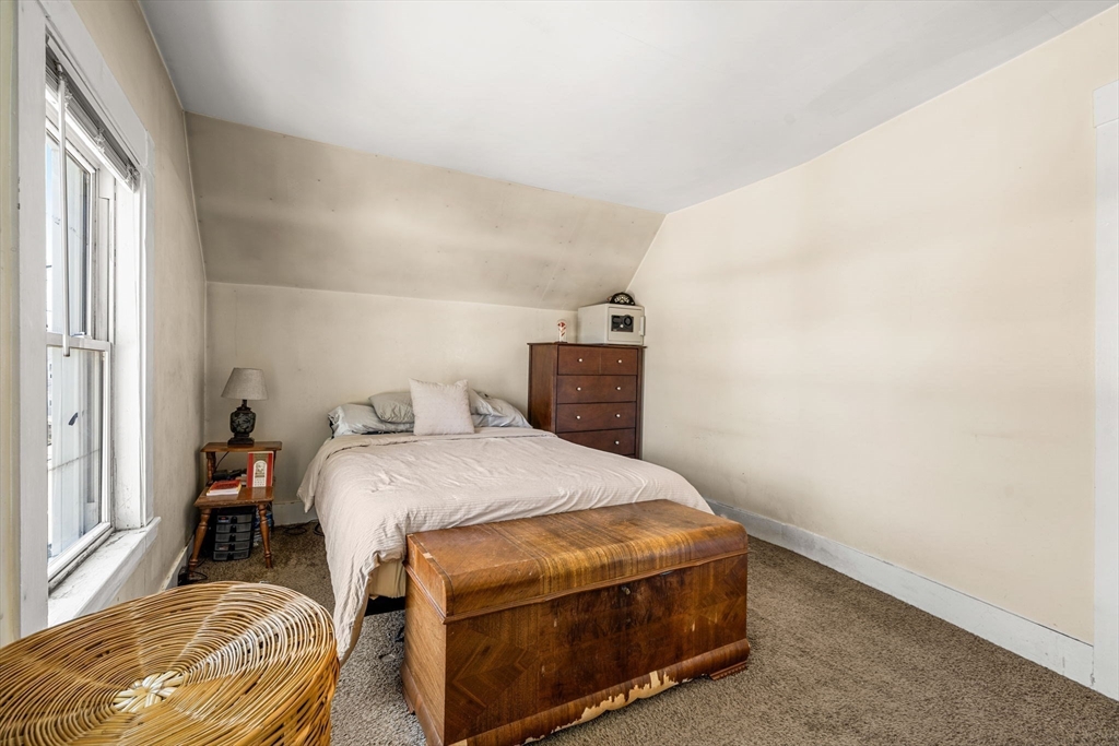 12 Arthur Street Gloucester, MA 01930 - Photo 20 of 33 a bedroom with a bed and a window