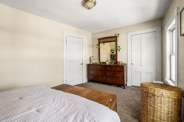 a bedroom with a bed and a dresser