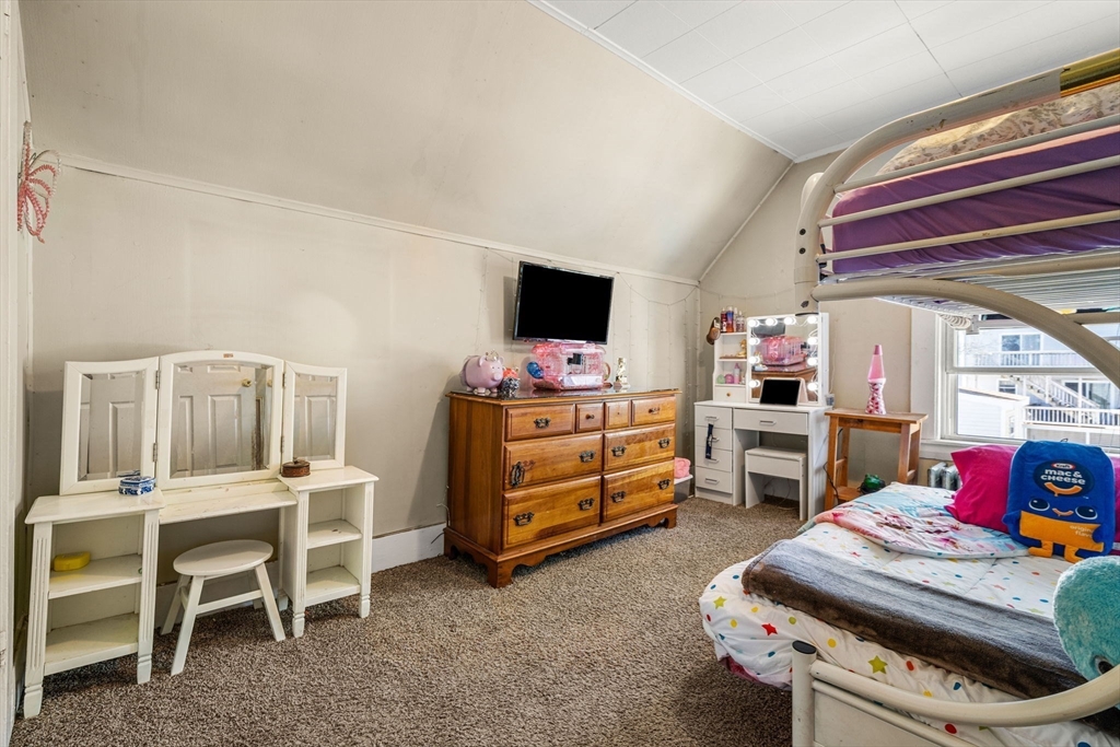 12 Arthur Street Gloucester, MA 01930 - Photo 23 of 33 a bedroom with a bed and a tv