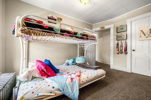 a bedroom with two beds and a window