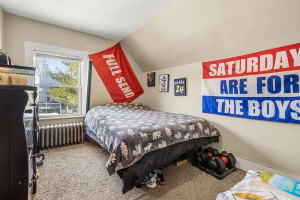 a bedroom with a bed and a book shelf