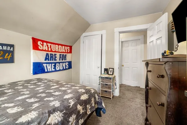 a bedroom with a bed and a television