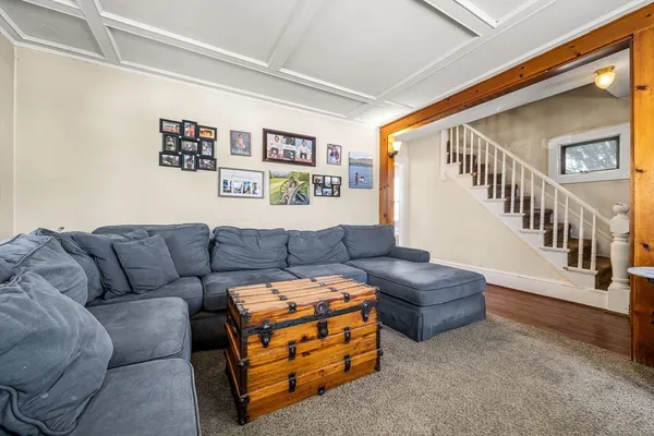 a living room with furniture and stairs