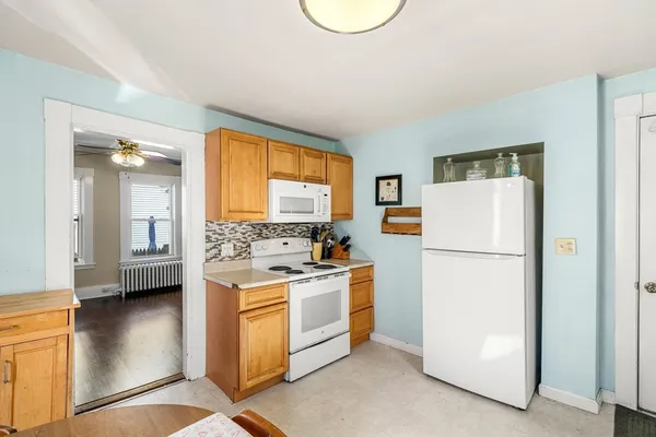 a kitchen with a refrigerator a stove a washer and a refrigerator