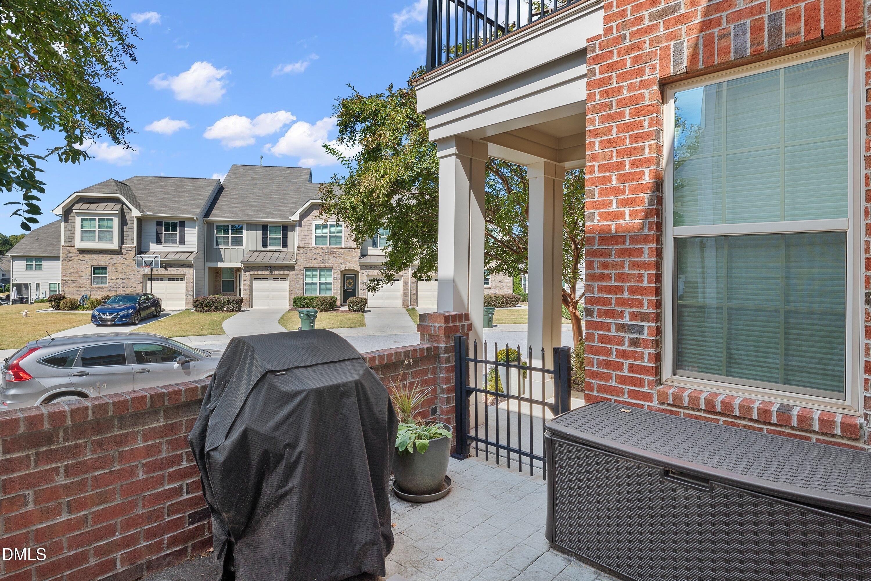 9302 Alcazar Walk Raleigh, NC 27617 - Photo 13 of 40 a front view of a house with outdoor seating and a potted plant