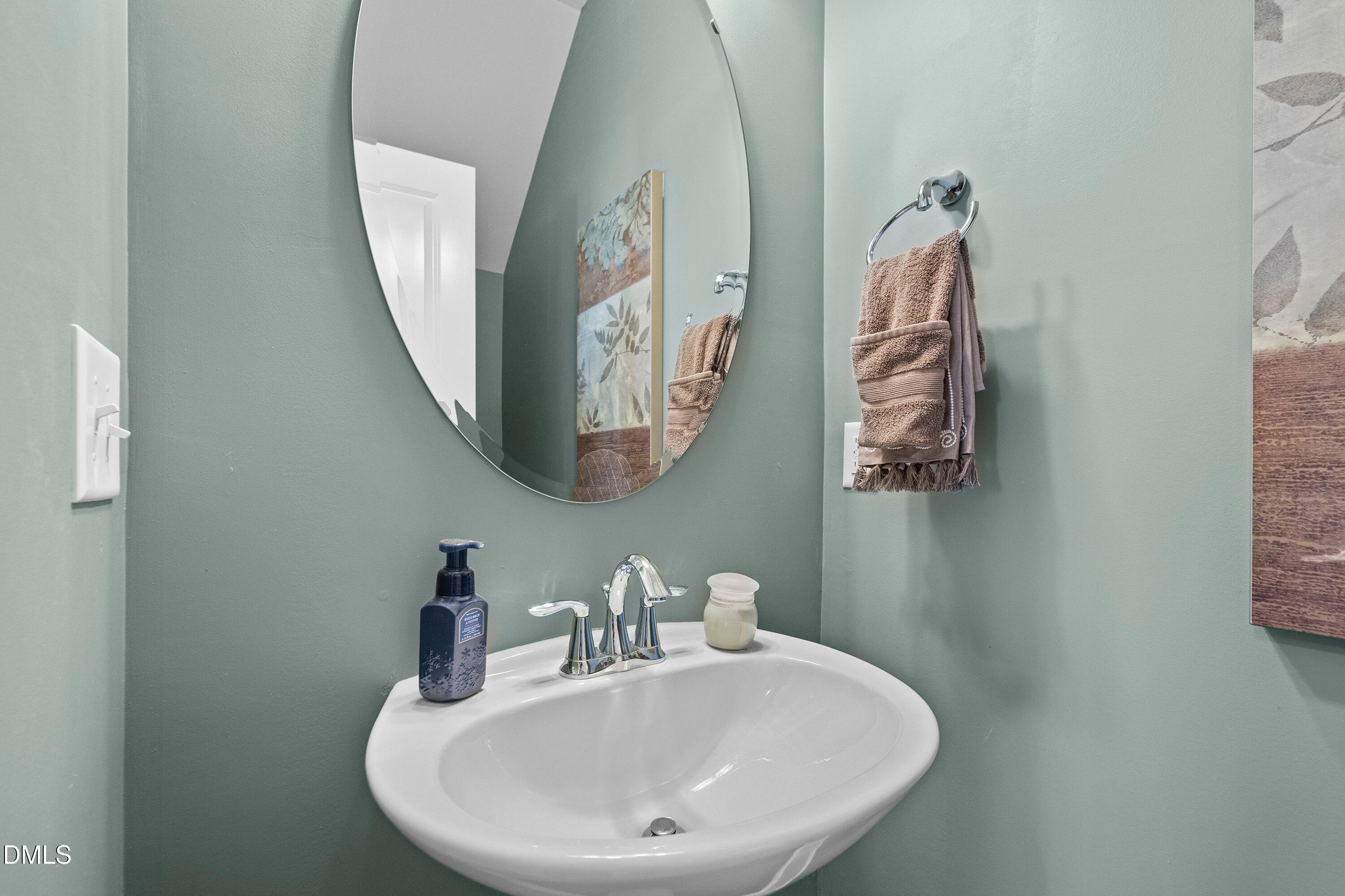 9302 Alcazar Walk Raleigh, NC 27617 - Photo 14 of 40 a bathroom with a sink and mirror