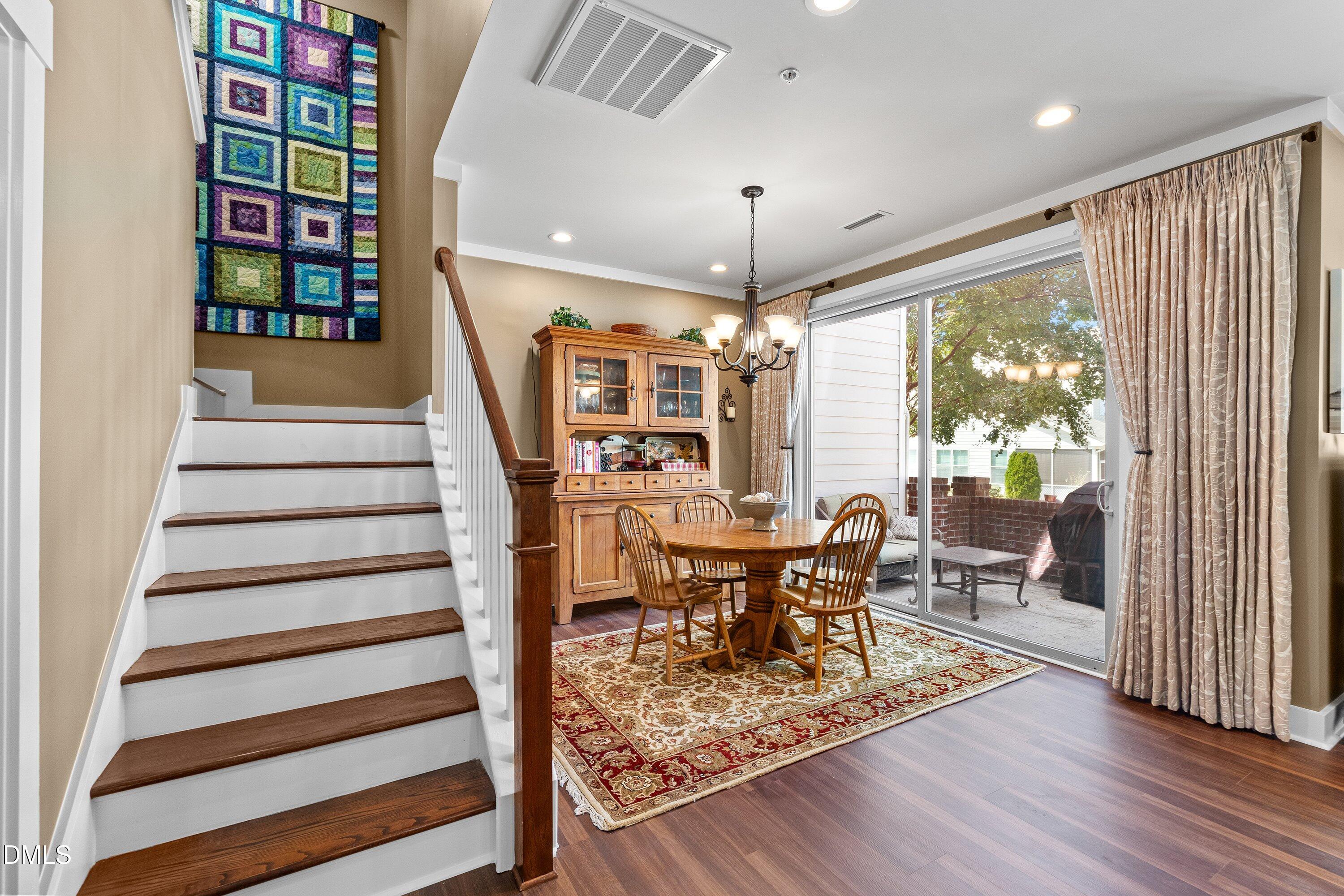 9302 Alcazar Walk Raleigh, NC 27617 - Photo 15 of 40 a view of a dining room with furniture window and wooden floor
