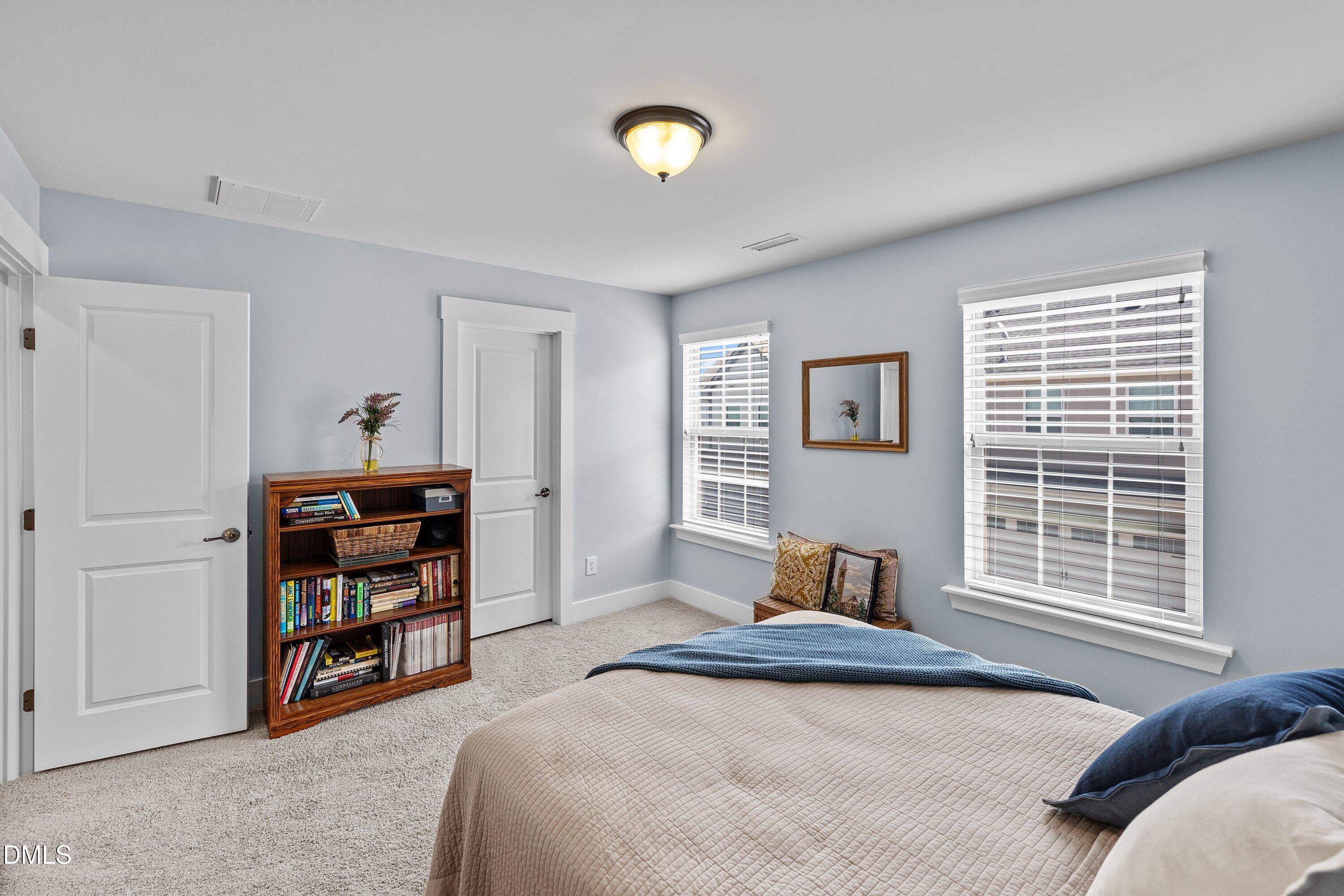 9302 Alcazar Walk Raleigh, NC 27617 - Photo 22 of 40 a bedroom with a bed and a window
