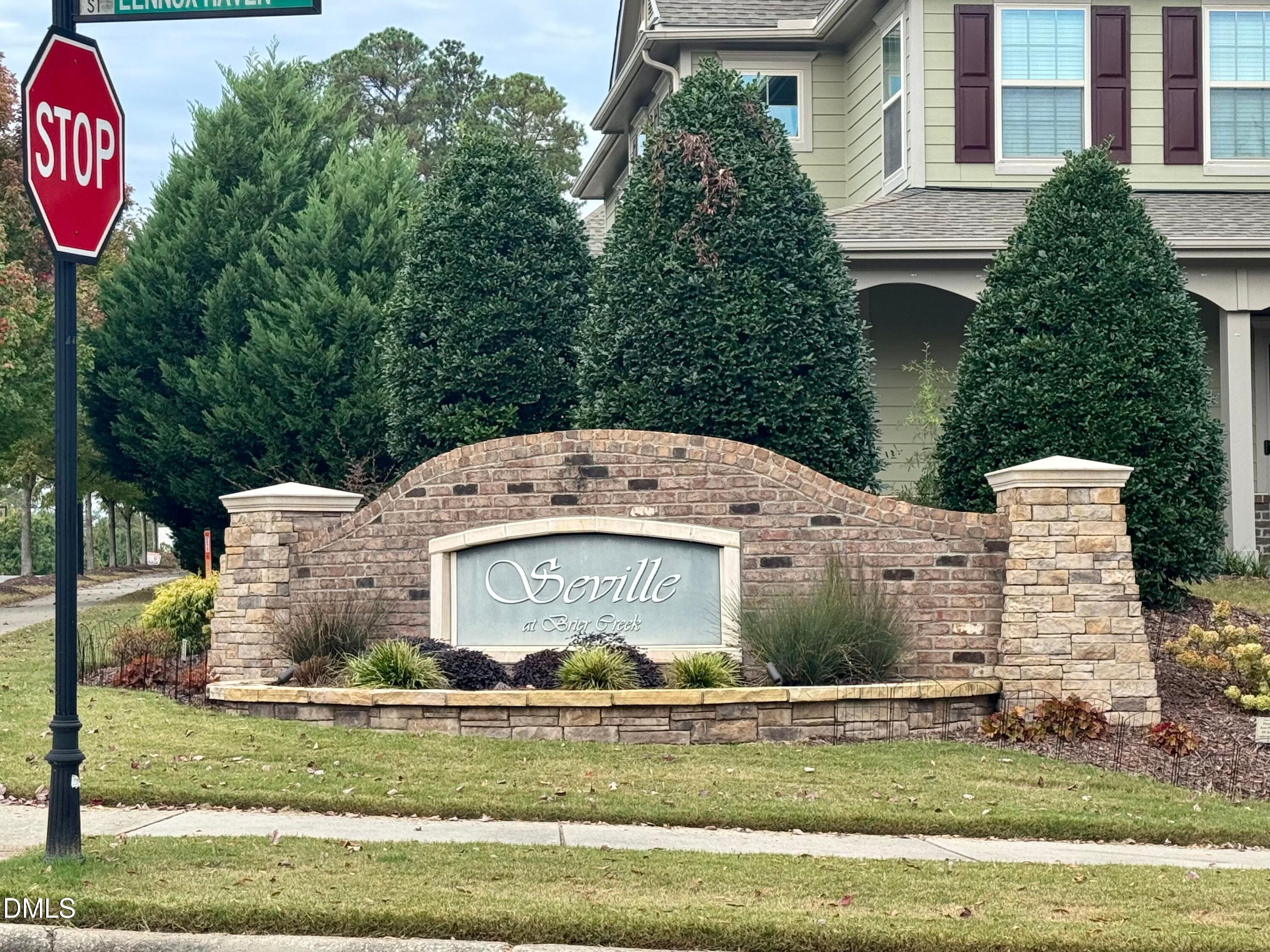 9302 Alcazar Walk Raleigh, NC 27617 - Photo 33 of 40 a front view of a house with a garden and tree