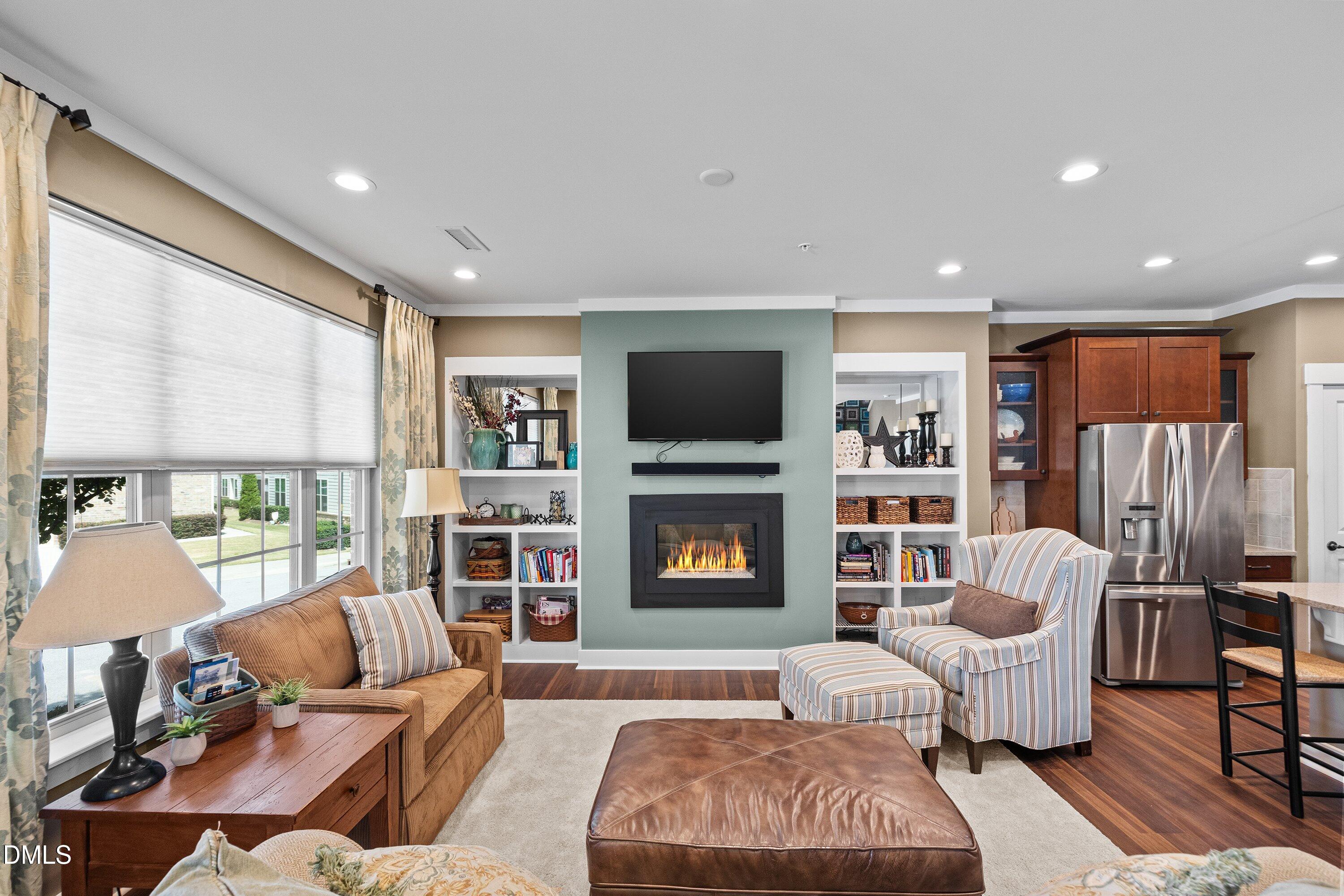 9302 Alcazar Walk Raleigh, NC 27617 - Photo 3 of 40 a living room with fireplace furniture and a flat screen tv