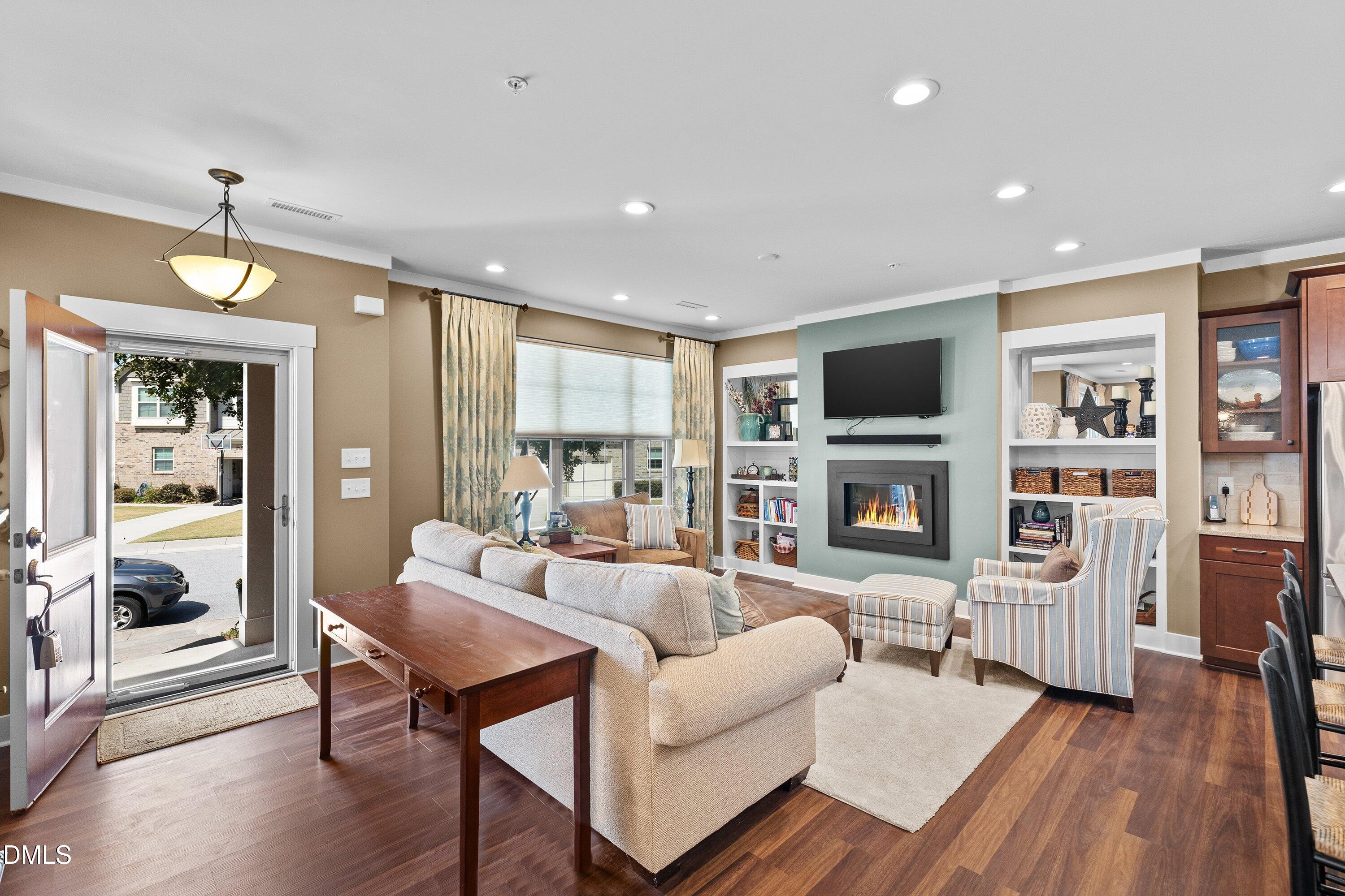 9302 Alcazar Walk Raleigh, NC 27617 - Photo 5 of 40 a living room with fireplace furniture and a flat screen tv