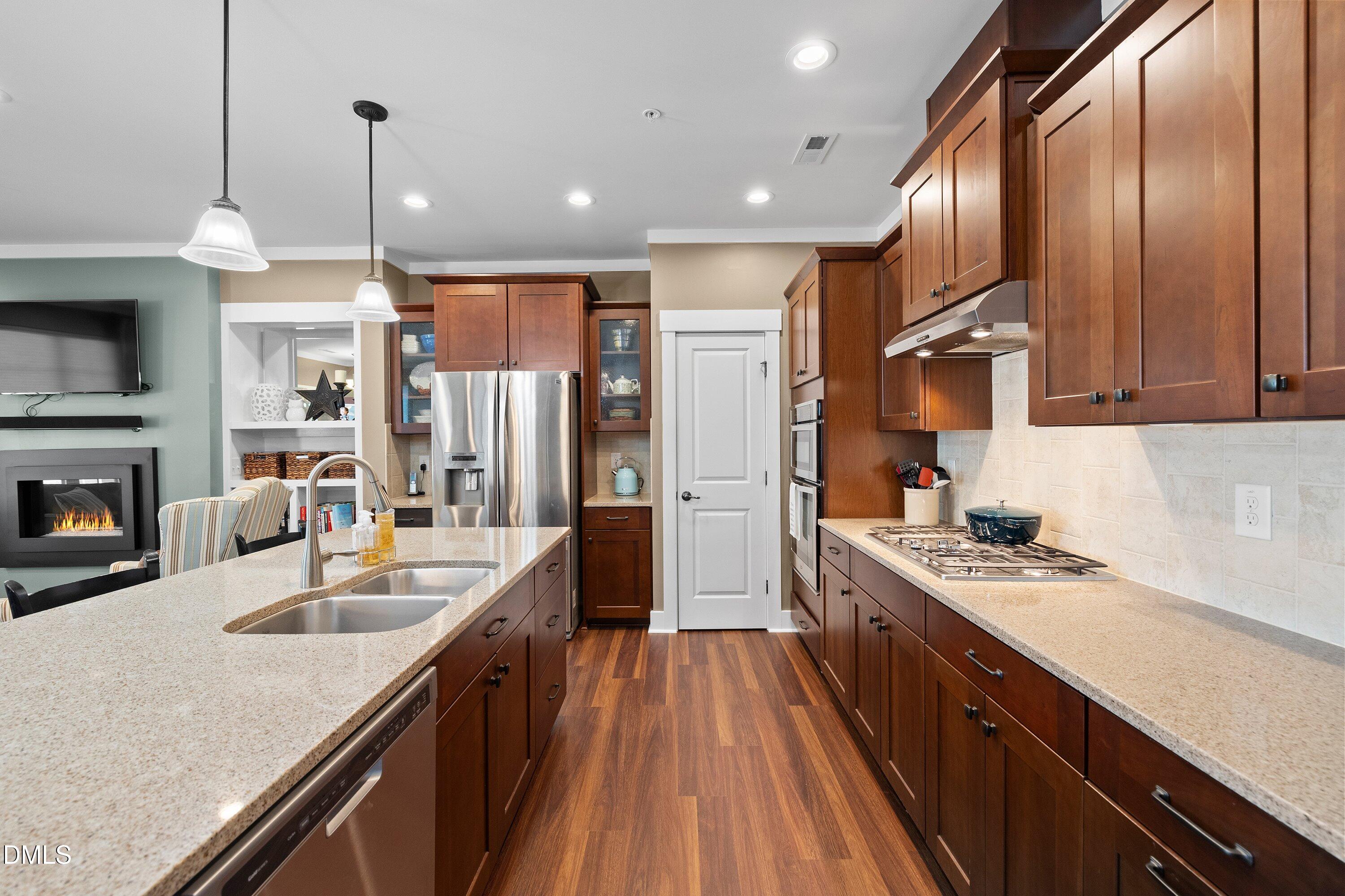 9302 Alcazar Walk Raleigh, NC 27617 - Photo 9 of 40 a kitchen with stainless steel appliances granite countertop a sink a stove and a refrigerator