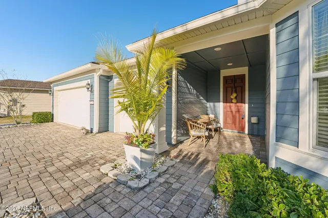 a spacious bedroom with a bed a couch and a chandelier