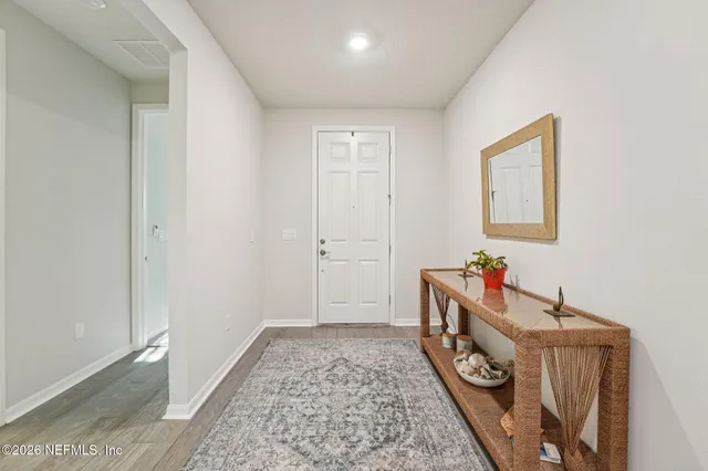a bathroom with a bathtub sink and mirror