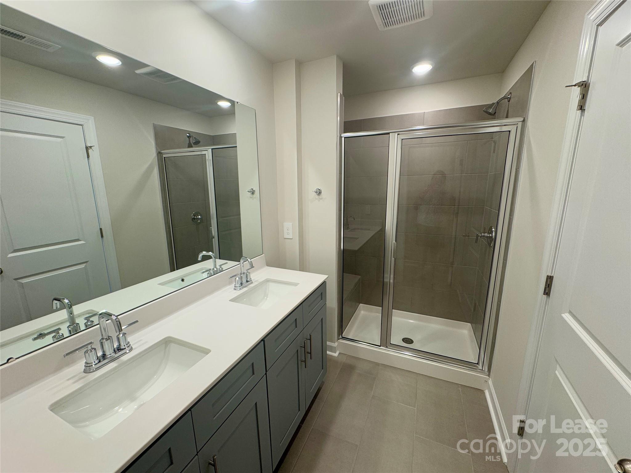 1650 Vlg Grv Lane Monroe, NC 28110 - Photo 22 of 23 a bathroom with a shower sink and mirror