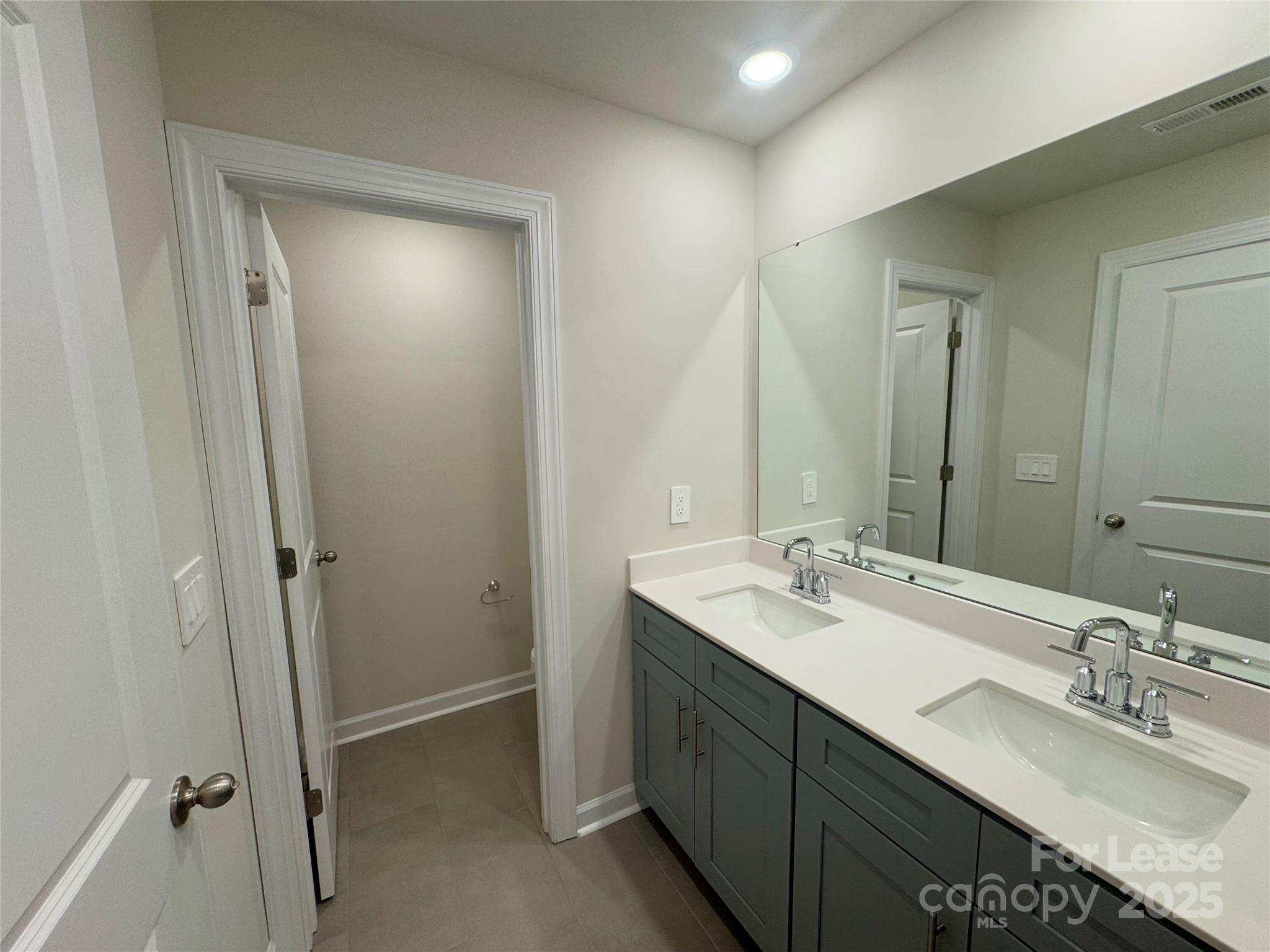 1650 Vlg Grv Lane Monroe, NC 28110 - Photo 23 of 23 a bathroom with a sink double vanity and a mirror