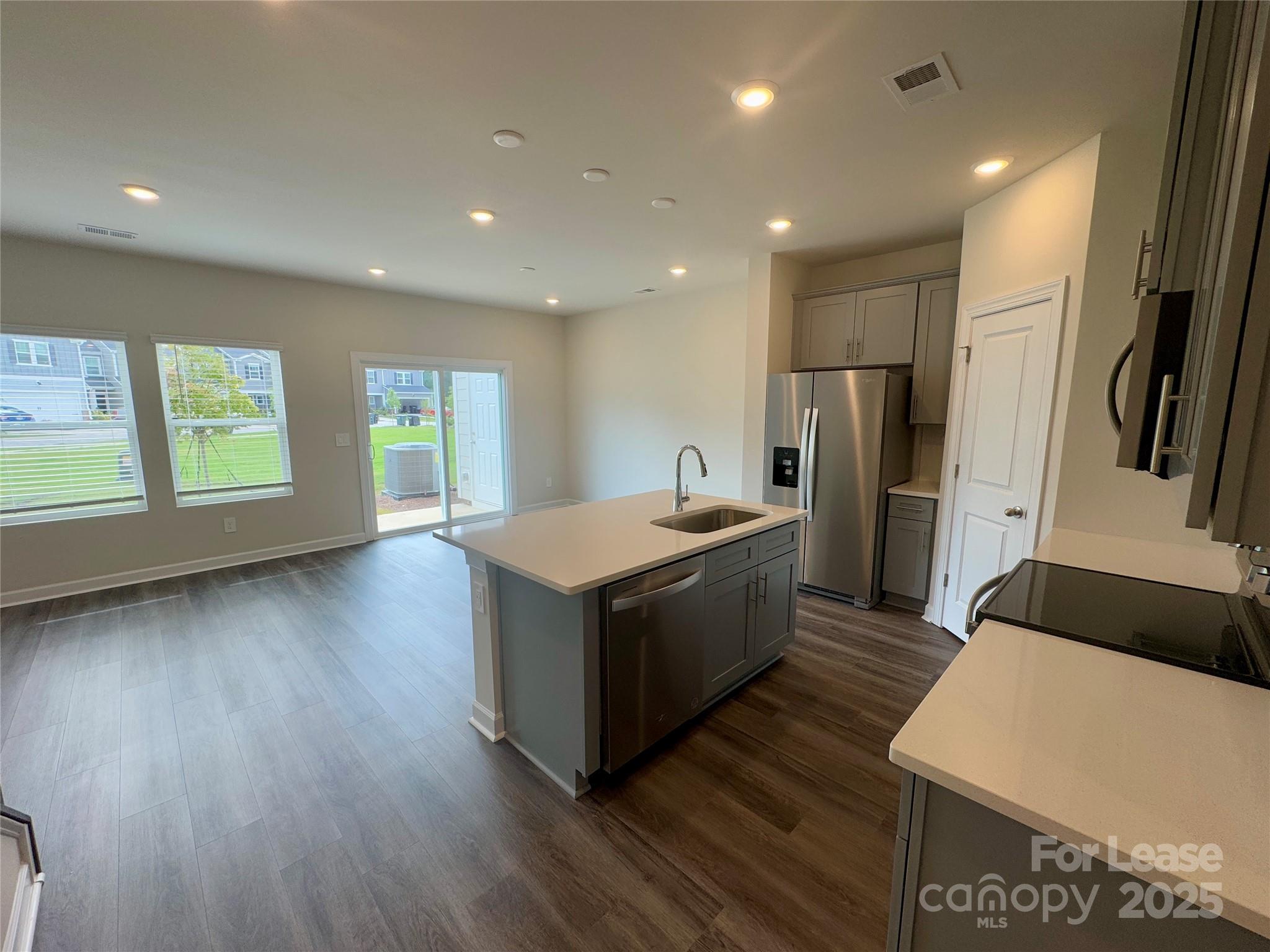 1650 Vlg Grv Lane Monroe, NC 28110 - Photo 7 of 23 a kitchen with stainless steel appliances granite countertop a refrigerator a sink dishwasher a stove and a refrigerator with wooden floor