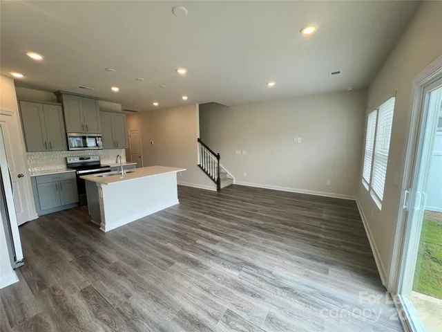 a view of kitchen with cabinets and wooden floor