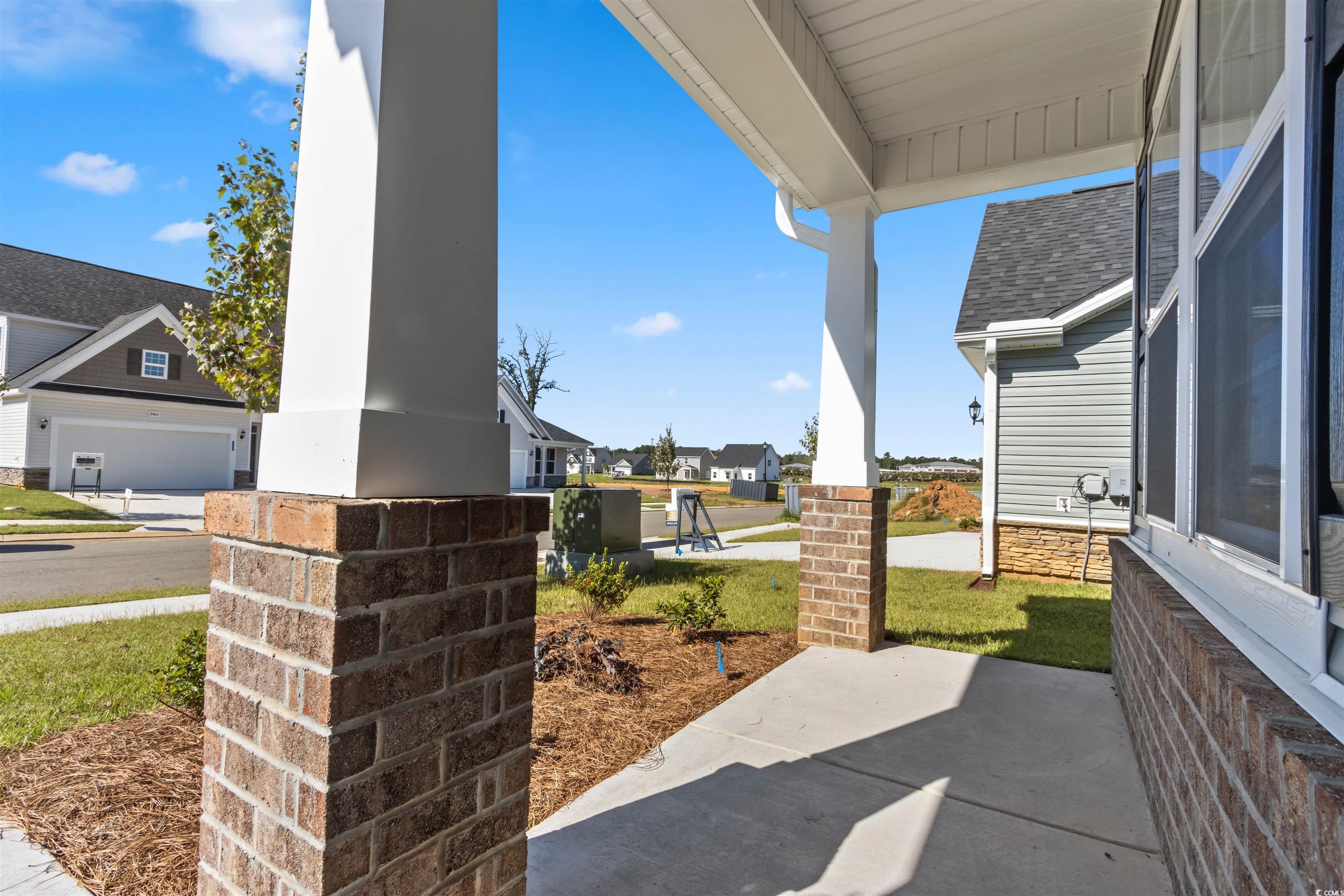 View of patio / terrace with a garage and a porch