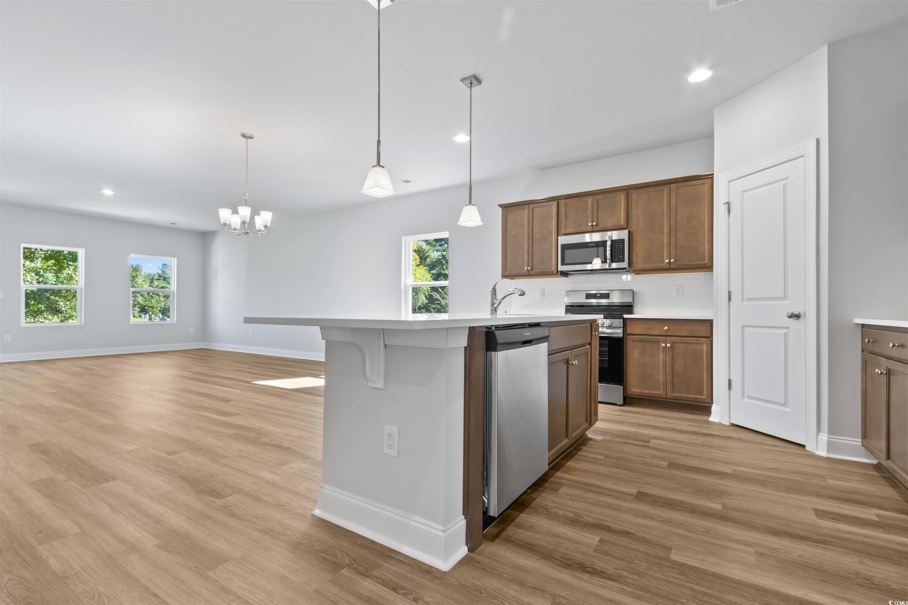 Kitchen with decorative light fixtures, hardwood /