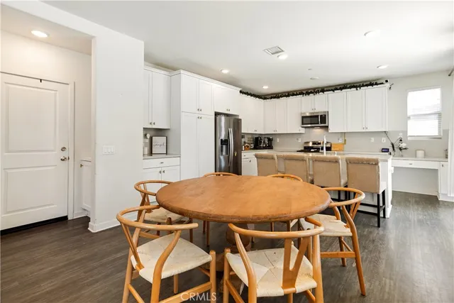 a kitchen with a sink a microwave a refrigerator and cabinets