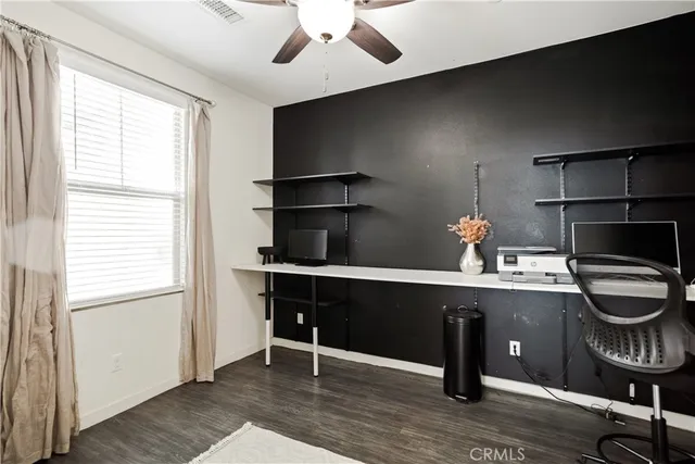 a room with a table chairs and wooden floor