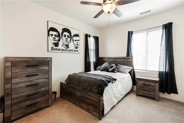 a bedroom with a bed and a dresser