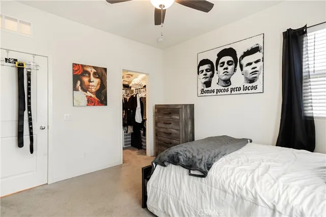 a bedroom with a bed a desk and chair