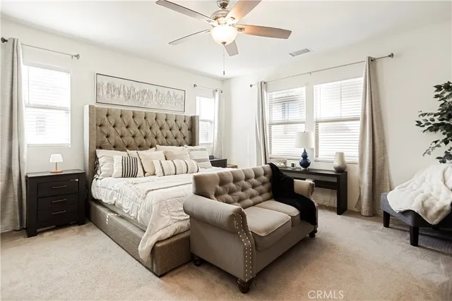 a bedroom with a bed and a couch