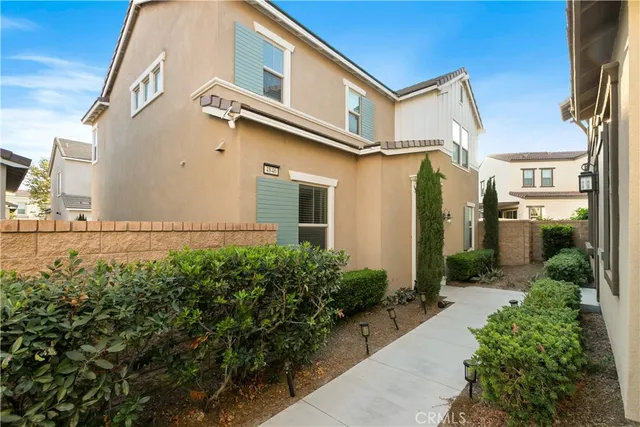 a view of a street with potted plants