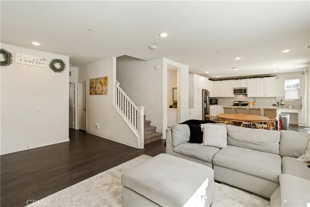 a kitchen with a dining table chairs and refrigerator