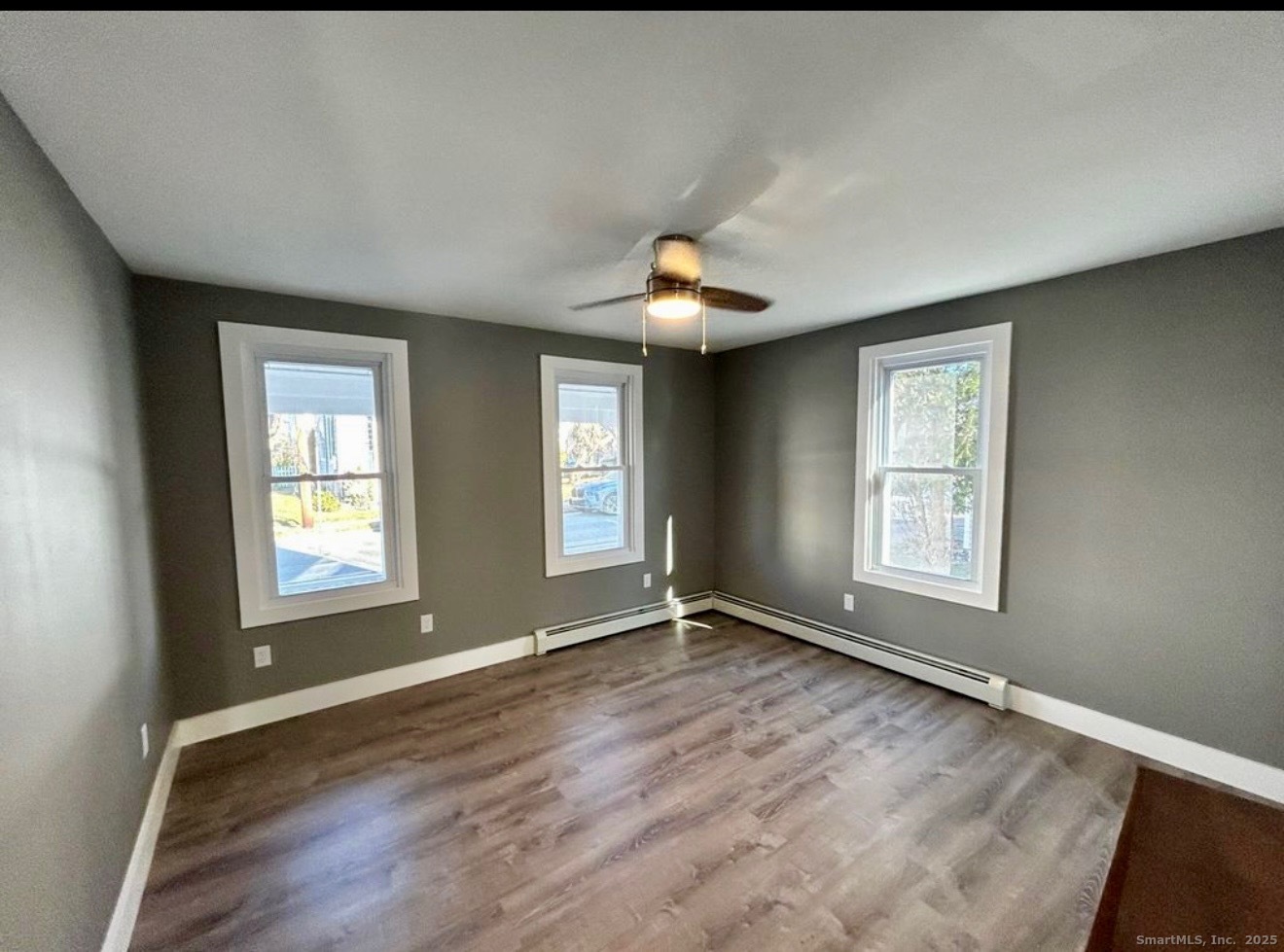 49 Trumbull Avenue Stonington, CT 06378 - Photo 6 of 14 a view of an empty room with a window and wooden floor
