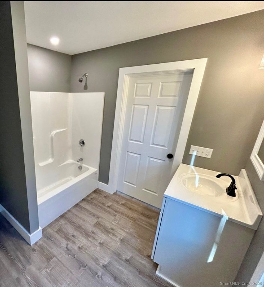 49 Trumbull Avenue Stonington, CT 06378 - Photo 7 of 14 a bathroom with a tub sink and mirror