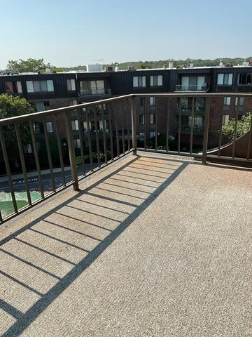 a view of balcony with wooden floor and city view