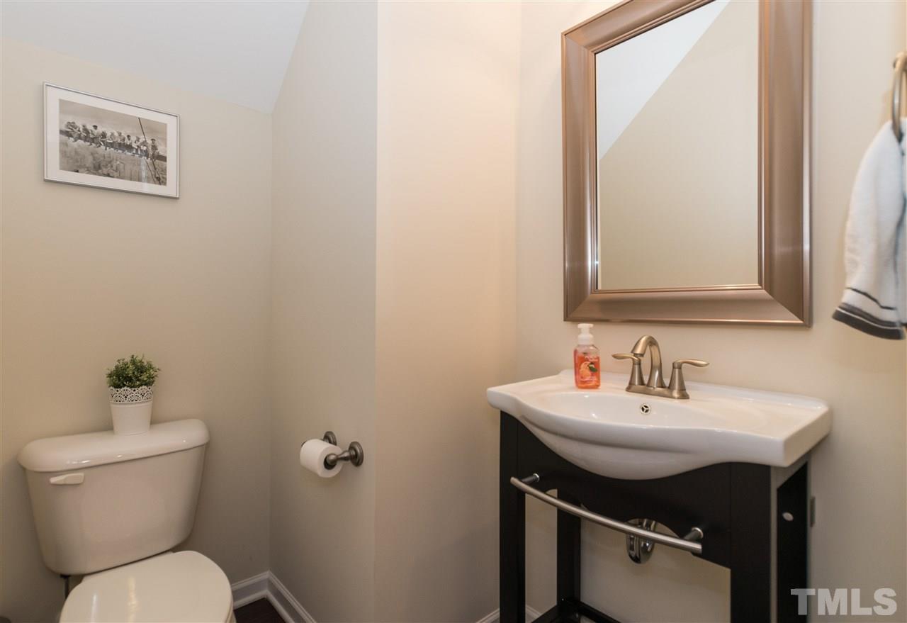 1345 Rodessa Run Raleigh, NC 27607 - Photo 14 of 24 a bathroom with a sink toilet and a mirror