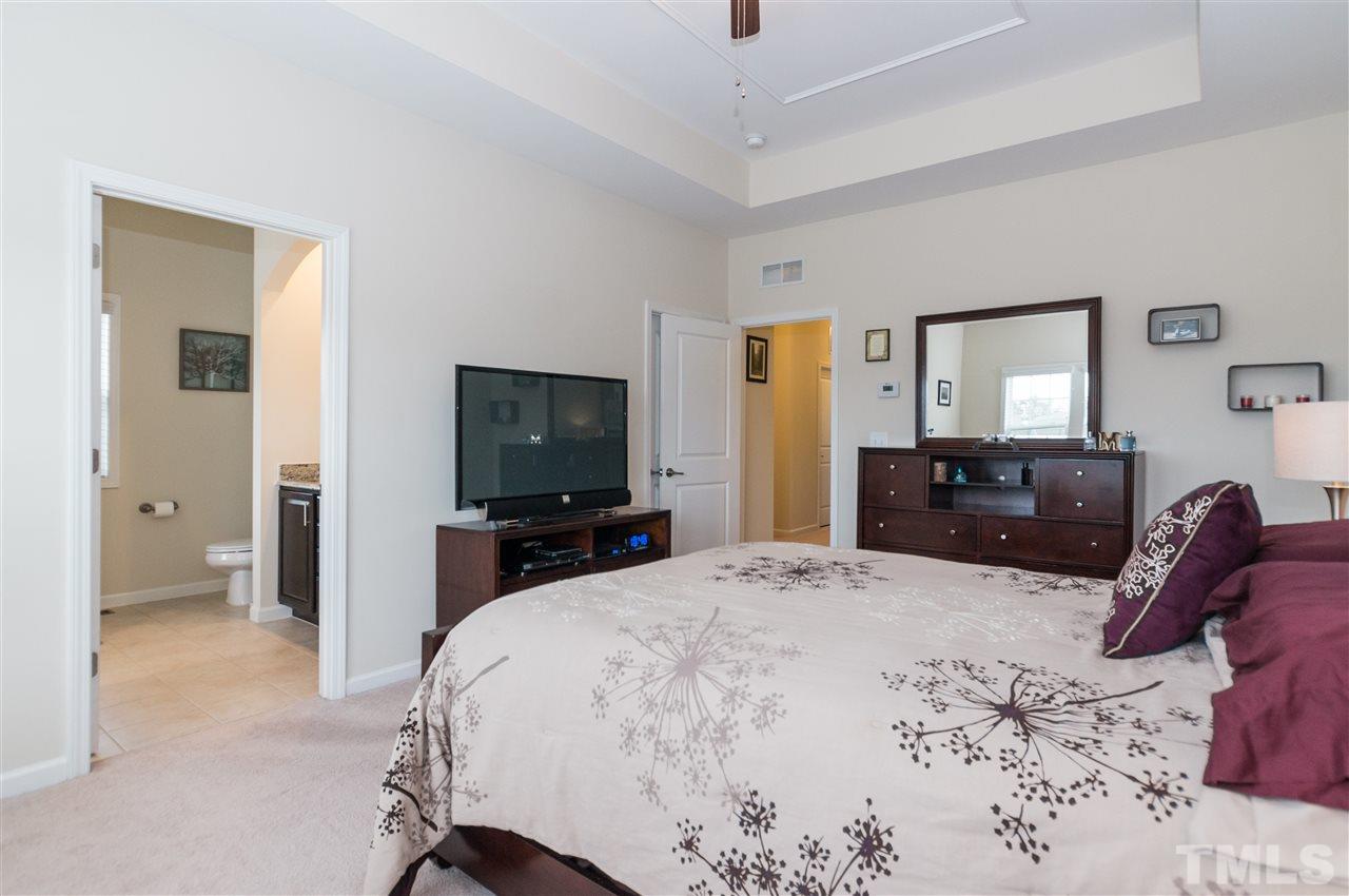 1345 Rodessa Run Raleigh, NC 27607 - Photo 17 of 24 a bedroom with a bed and a flat tv screen on dresser