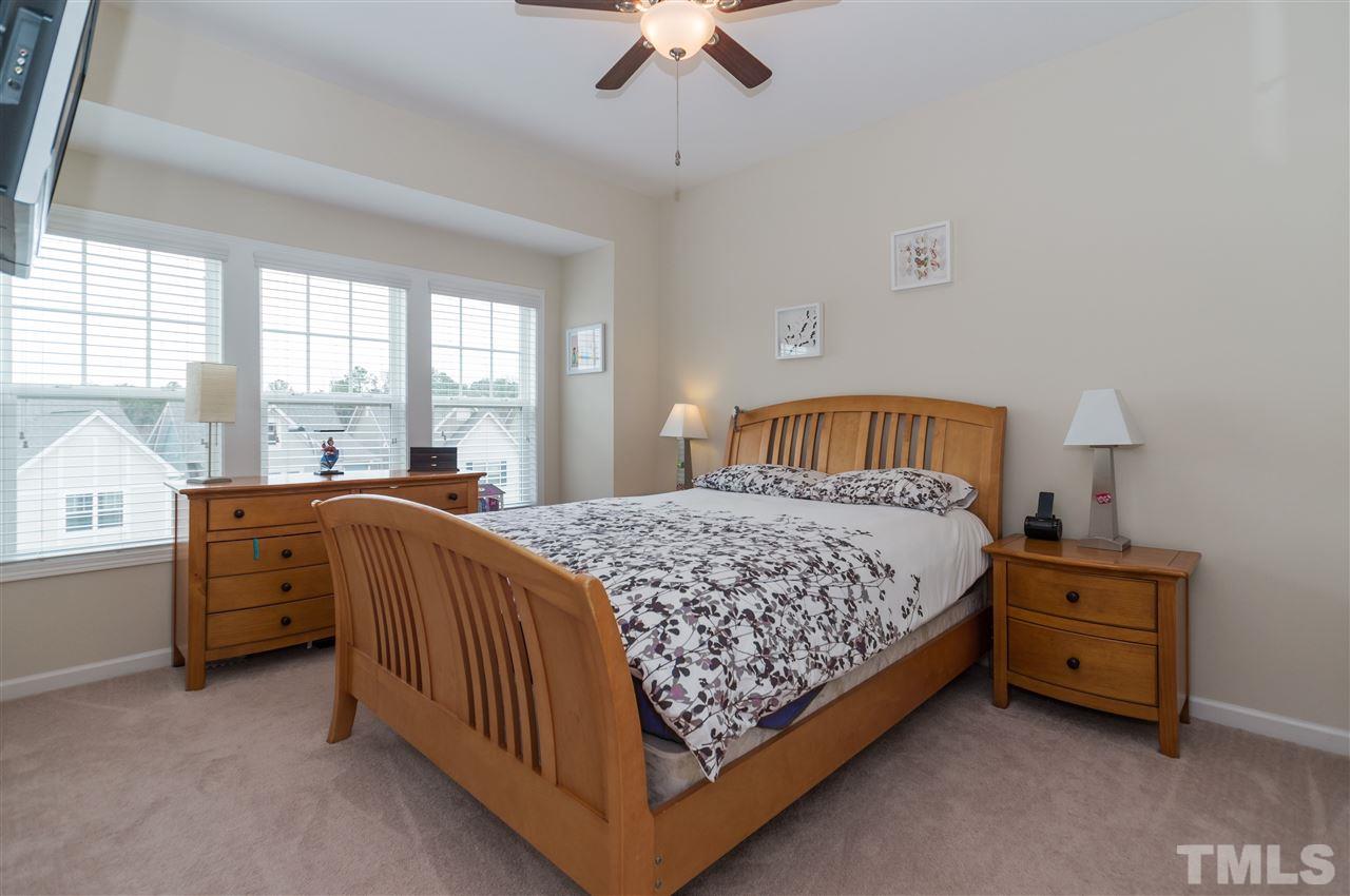 1345 Rodessa Run Raleigh, NC 27607 - Photo 20 of 24 a bedroom with a bed dresser and a window