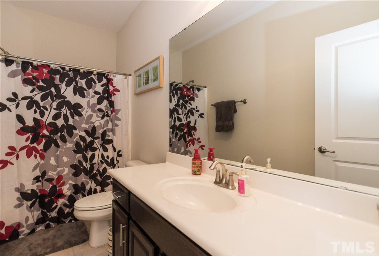 1345 Rodessa Run Raleigh, NC 27607 - Photo 21 of 24 a bathroom with a sink and a mirror