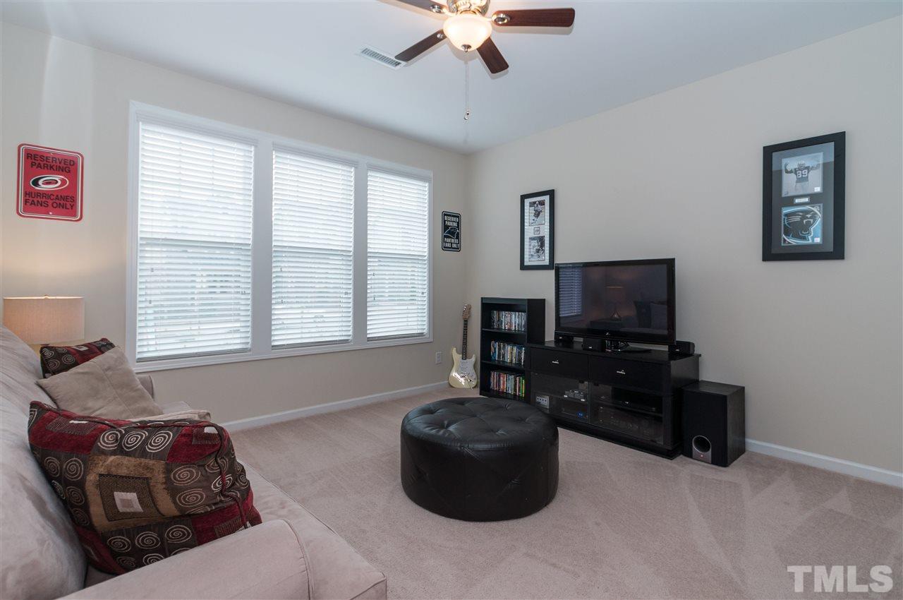 1345 Rodessa Run Raleigh, NC 27607 - Photo 4 of 24 a living room with furniture and a flat screen tv
