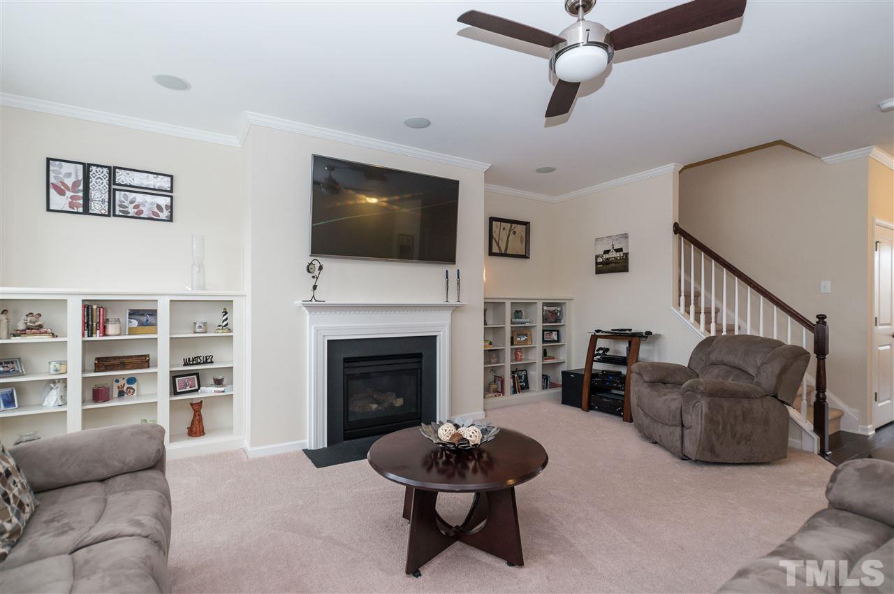 1345 Rodessa Run Raleigh, NC 27607 - Photo 6 of 24 a living room with furniture a flat screen tv and a fireplace