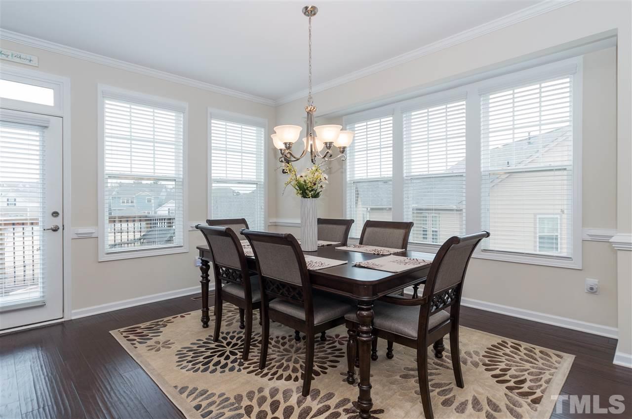 1345 Rodessa Run Raleigh, NC 27607 - Photo 9 of 24 a view of a dining room with furniture window and wooden floor