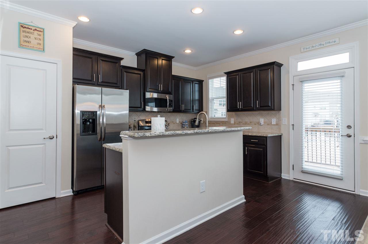 1345 Rodessa Run Raleigh, NC 27607 - Photo 10 of 24 a kitchen with stainless steel appliances granite countertop a refrigerator stove a sink and a microwave